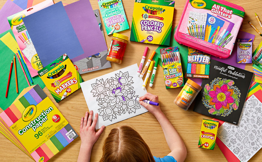 Photo of child making art with Crayola products